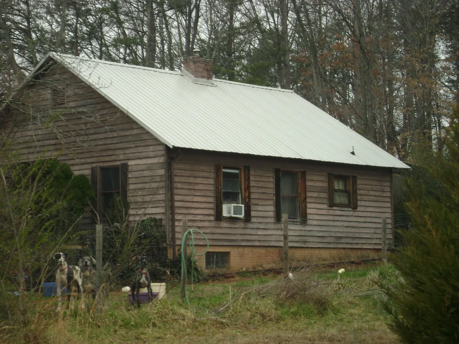 White metal roof on an old wood sided farmhouse, from a Metal Roof Installation job in Rockfield